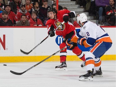 Mark Stone #61 of the Ottawa Senators shoots the puck against Nick Leddy #2 of the New York Islanders.