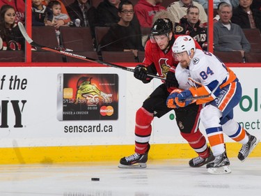 Bobby Ryan #6 of the Ottawa Senators battles for puck possession against Mikhail Grabovski #84 of the New York Islanders.