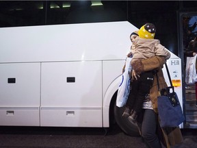 Newly-arrived Syrian refugees arrive at a hotel in Toronto on Tuesday, December 15, 2015. Through pub nights, crowd funding websites, church suppers and craft bazaars, thousands of Canadians are currently trying to raise money to sponsor a Syrian refugee. THE CANADIAN PRESS/Nathan Denette
