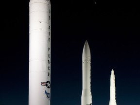 A static display of intercontinental ballistic missiles at the F.E. Warren Air Force Base, Wyo., front gate the evening of April 4, 2012. From left are the Peacekeeper, the Minuteman III and the Minuteman I. The planet Venus is visible in the sky above the Minuteman missiles and Jupiter is visible to the left of the Minuteman I. (U.S. Air Force photo by R.J. Oriez)