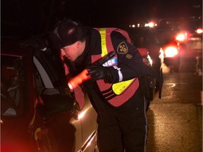 An OPP officer conducts a RIDE program roadside check.