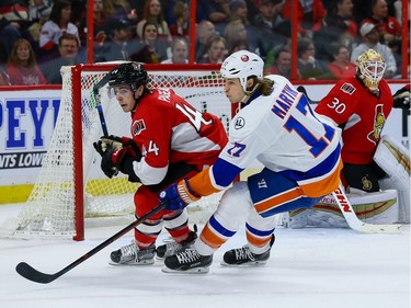 Ottawa Senators center Jean-Gabriel Pageau (44) is pursued by New York Islanders left wing Matt Martin (17) as Sens Andrew Hammond and Erik Karlsson (65) follow the play.
