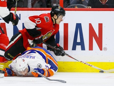 Ottawa Senators center Shane Prince (10) plays the puck over top of New York Islanders defenseman Travis Hamonic (3).