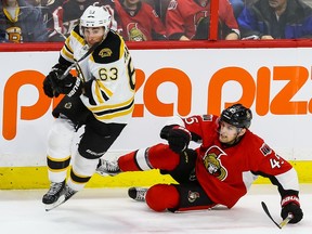The Bruins' Brad Marchand, seen skating away from downed Senators defenceman Chris Wideman, will make his return from a suspension against Ottawa. He was suspended for submarining the Sens' Mark Borowiecki.
