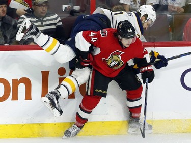 Ottawa Senators' Jean-Gabriel Pageau (44) checks Buffalo Sabres' Zemgus Girgensons (28) during first period NHL action.