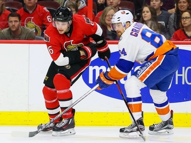 Ottawa Senators right wing Bobby Ryan (6) fights past the check of New York Islanders center Mikhail Grabovski (84).