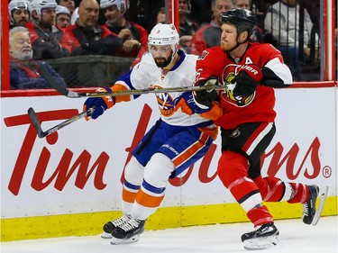 Ottawa Senators right wing Chris Neil (25) checks New York Islanders defenseman Nick Leddy (2).