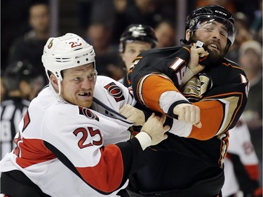 Ottawa Senators right wing Chris Neil, left, brawls with Anaheim Ducks left wing Patrick Maroon during the second period of an NHL hockey game in Anaheim, Calif., Wednesday, Jan. 13, 2016.