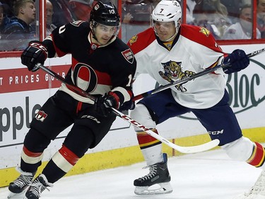Ottawa Senators' Shane Prince (10) is checked by Florida Panthers' Dmitry Kulikov (7) during the first period.