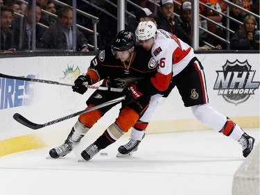 ANAHEIM, CA - JANUARY 13:  Jakob Silfverberg #33 of the Anaheim Ducks battles Patrick Wiercioch #46 of the Ottawa Senators for position during the first period of a game at Honda Center on January 13, 2016 in Anaheim, California.