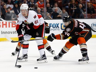 Senators winger Mark Stone (61) passes the puck under defensive pressure from the Ducks' Nate Thompson (44) during the second period of Wednesday night's game at the Honda Center in Anaheim.