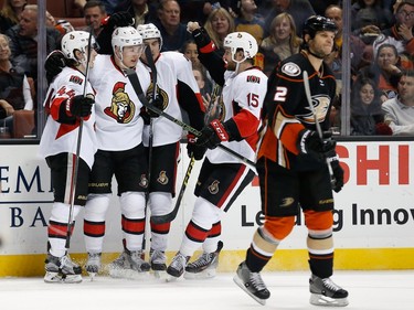 ANAHEIM, CA - JANUARY 13:  Jean-Gabriel Pageau #44, Zack Smith #15 and Cody Ceci #5 of the Ottawa Senators congratulate Curtis Lazar #27 after he scored a goal during the second period against the Anaheim Ducks skates during a game at Honda Center on January 13, 2016 in Anaheim, California.