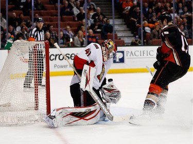 ANAHEIM, CA - JANUARY 13:  Craig Anderson #41 of the Ottawa Senators blocks a shot on goal by Ryan Getzlaf #15 of the Anaheim Ducks during the first period of a game at Honda Center on January 13, 2016 in Anaheim, California.