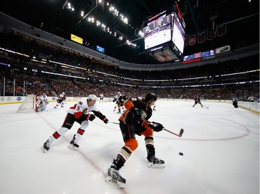 ANAHEIM, CA - JANUARY 13:  Cody Ceci #5 of the Ottawa Senators chases Shawn Horcoff #22 of the Anaheim Ducks during the first period of a game at Honda Center on January 13, 2016 in Anaheim, California.