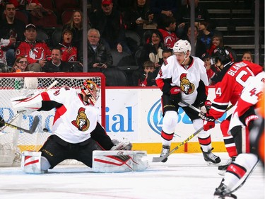 Joseph Blandisi #64 of the New Jersey Devils scores his first NHL goal against Craig Anderson #41 of the Ottawa Senators during the first period.