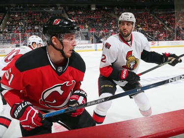 Jared Cowen #2 of the Ottawa Senators lines up Sergey Kalinin #51 of the New Jersey Devils for a second period hit.