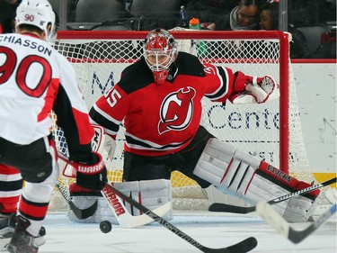 Cory Schneider #35 of the New Jersey Devils makes the first period save against the Ottawa Senators.
