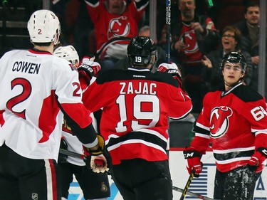 Travis Zajac #19 of the New Jersey Devils celebrates his goal at 13:56 of the first period against the Ottawa Senators along with Joseph Blandisi #64.