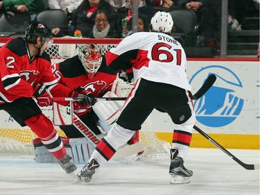 Cory Schneider #35 of the New Jersey Devils makes the first period stop on Mark Stone #61 of the Ottawa Senators.