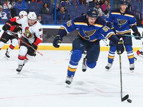 Colton Parayko #55 of the St. Louis Blues chases down the puck against Shane Prince #10 of the Ottawa Senators.