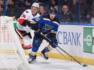 Robby Fabbri #15 of the St. Louis Blues looks to pass the puck against Mark Borowiecki #74 of the Ottawa Senators.