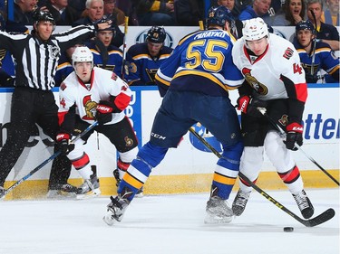 Colton Parayko #55 of the St. Louis Blues knocks Chris Wideman #45 of the Ottawa Senators off the puck.