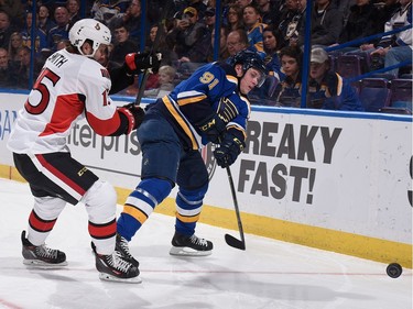 Vladimir Tarasenko #91 of the St. Louis Blues passes the puck against Zack Smith #15 of the Ottawa Senators.