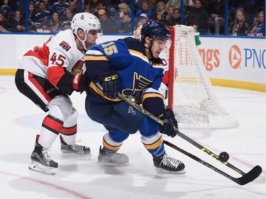 Chris Wideman #45 of the Ottawa Senators and Robby Fabbri #15 of the St. Louis Blues chase down the puck.