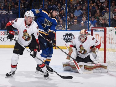 Magnus Paajarvi #56 of the St. Louis Blues deflects the puck to the goal against Patrick Wiercioch #46 and Andrew Hammond.