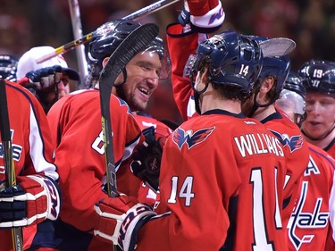Alex Ovechkin #8 of the Washington Capitals celebrates his 500th career NHL goal in the second period with teammate Justin Williams #14 against the Ottawa Senators at the Verizon Center on January 10, 2016 in Washington, DC.