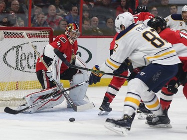 Senators Craig Anderson watches Sabres Marcus Foligno go to the net during second period action.
