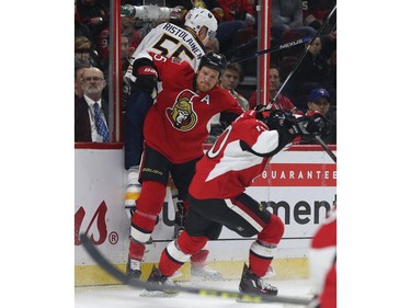 Senators Chris Neil checks Sabres Rasmus Ristolainen during first period action.