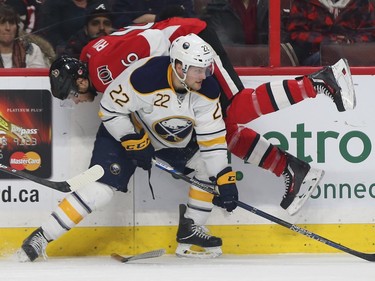 Senators Bobby Ryan goes for a ride after getting hit by Sabres Johan Larsson during first period action.