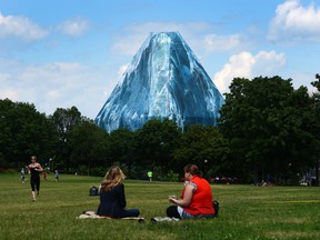 People visit Major's Hill Park in view of a giant iceberg installation covering a network of scaffolding at the National Gallery in 2013.