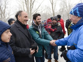 Recently arrived refugees are greeted by Governor General David Johnston during the Winter Celebration at Rideau Hall on Saturday.