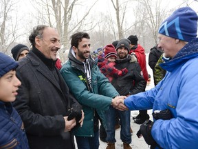 Recently arrived refugees are greeted by Gov. Gen. David Johnston during the Winter Celebration at Rideau Hall on Saturday, Jan. 16, 2016.