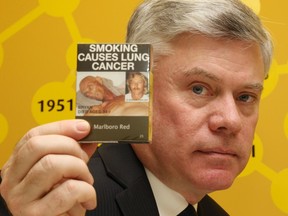 Rob Cunningham, Senior Policy Analyst, Canadian Cancer Society, holds some cigarette packaging from Australia.