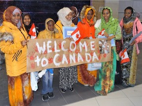 A group of 14 Ottawa residents sponsored an Eritrean family for refugee status in Canada. Halima Mohamed Ali (second from left) and her seven children, aged nine to 25, arrived on Thursday Jan. 21 and were presented with a welcome banner by the Breezehill Sponsorship Group.
