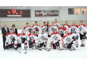 The winning Esprit de Corps Commando team poses for a photo after the Commando Challenge IV fundraising hockey game held at the University of Ottawa ice rink on Thursday, January 28, 2016.