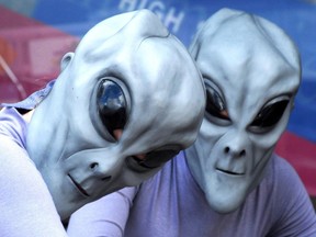 Two 'aliens' pose during a UFO Festival in Roswell, New Mexico, which some believe was the site of a spaceship crash in 1947.