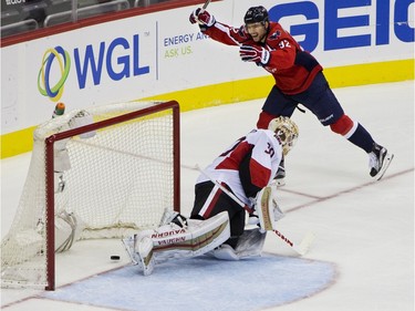 Washington Capitals center Evgeny Kuznetsov (92) celebrates as the puck gets past Ottawa Senators goalie Andrew Hammond (30) for a goal scored by Capitals right wing Justin Williams (14) during the first period of a NHL hockey game in Washington, D.C., Sunday, Jan. 10, 2016.