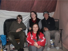 Susan Harper, foreground, and supporters, from left, Matthew Allan, Johanne DeHamel and Danny Homer at the sacred fire site on Victoria Island.
