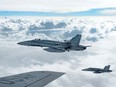 Royal Canadian Air Force CF-18 Hornets depart after refueling with a KC-135 Stratotanker assigned to the 340th Expeditionary Air Refueling Squadron, October 30, 2014, over Iraq. USAF photo.