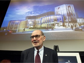 Peter Herrndorf  stands in front of an artist's rendering of the National Arts Centre's new Elgin Street look.