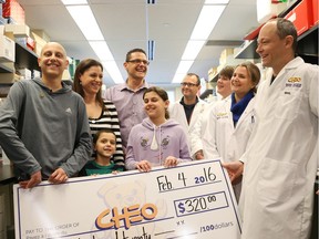 Elias Hawa, left, with family members and CHEO researchers including Dr. David Stojdl.