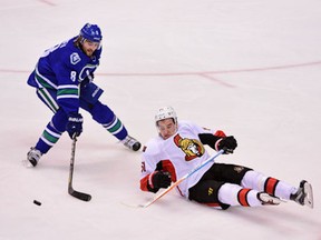 Ottawa Sentators forward Mark Stone goes down against Vancouver Canucks defenceman Christopher Tanev during the second period at Rogers Arena in Vancouver on Feb. 25, 2016.