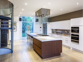 A custom glass and stainless-steel ceiling hood perfectly complements other elements in a redesign of entrepreneur Michael Potter’s kitchen by Nathan Kyle of Astro Design Centre.