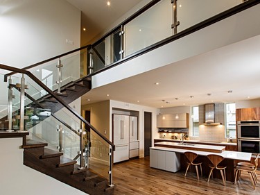 The glass, stainless-steel and oak staircase and hallway railing continue the home's airy, modern theme and allow light from the ample glazing to penetrate the interior.