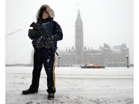 An RCMP officer stands on guard on Parliament Hill during a winter storm Tuesday.