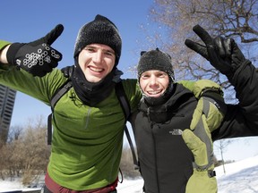 Anthony Bacon, left, and George Balderston take a break from running their own marathon through Ottawa after Winterlude organizers cancelled the Winterman Marathon due to frigid temperatures.